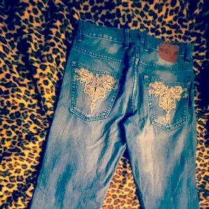 Loosefit washed blue denim wide leg ripped jeans with design on the back pockets